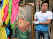 Catholics carry a portrait of the Virgin Mary in China’s Hebei Province on May 26, 2013.